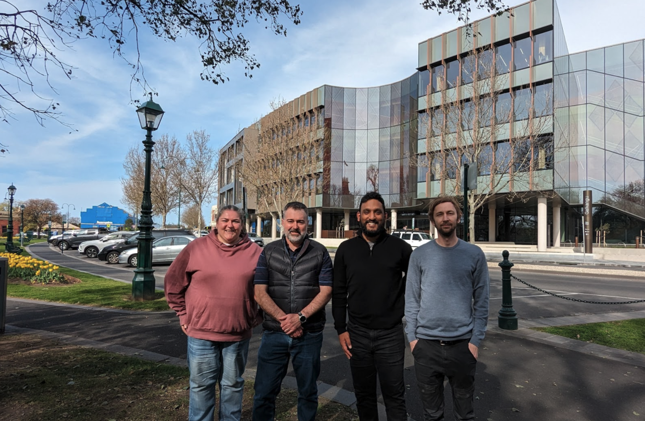 Picture of the team standing in front of council building smiling